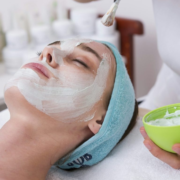 Client receiving a customized facial treatment with a hydrating mask applied by a professional